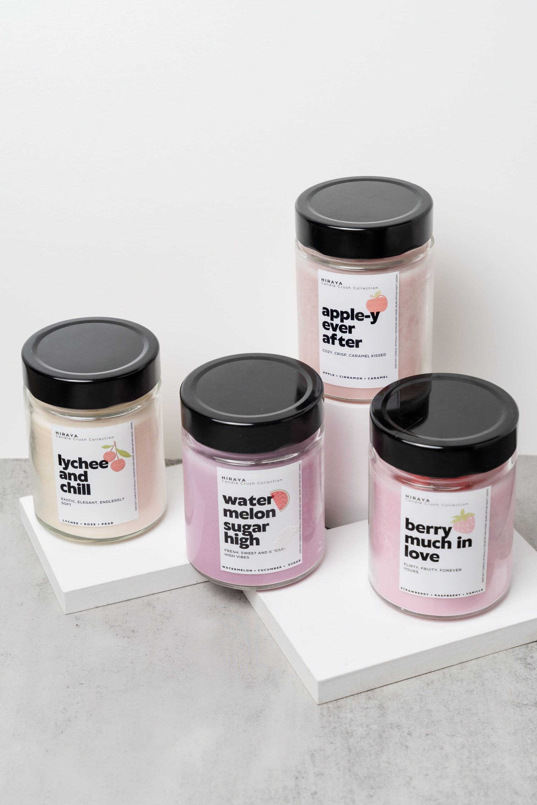 Group display of the Candle Crush Collection featuring Berry Much in Love, Apple‑y Ever After, Watermelon Sugar High, and Lychee and Chill candles.