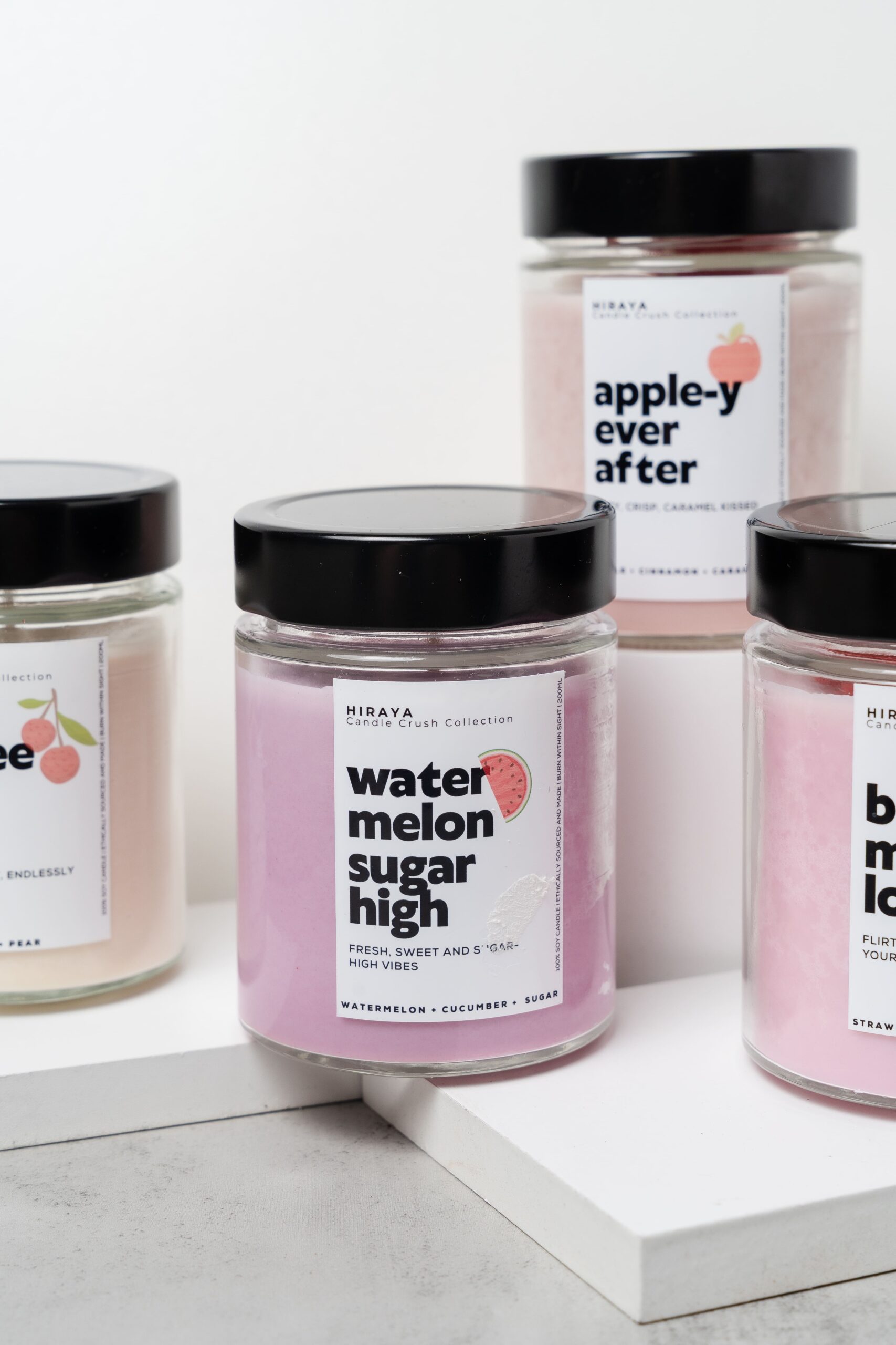 Group display of the Candle Crush Collection featuring Berry Much in Love, Apple‑y Ever After, Watermelon Sugar High, and Lychee and Chill candles.