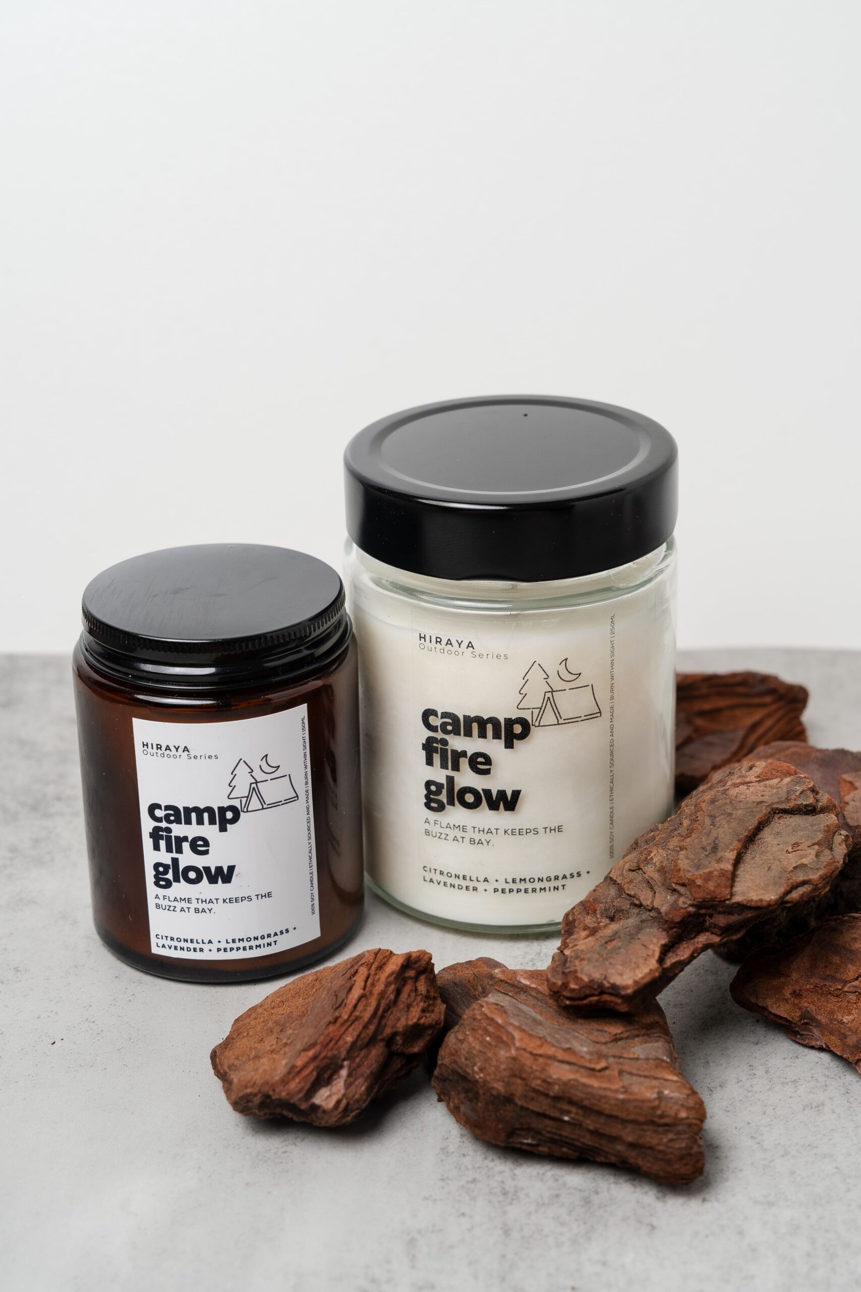 Styled display of Campfire Glow candles in both 150ml and 280ml sizes.