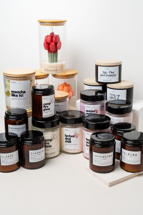 “Group photo of Hiraya Home & Scents Co. candles from all collections, including Floral, Café, Aromatherapy, Amber Oud, Signature Label, Molded Candles, and Outdoor scents, arranged together on a styled display.”