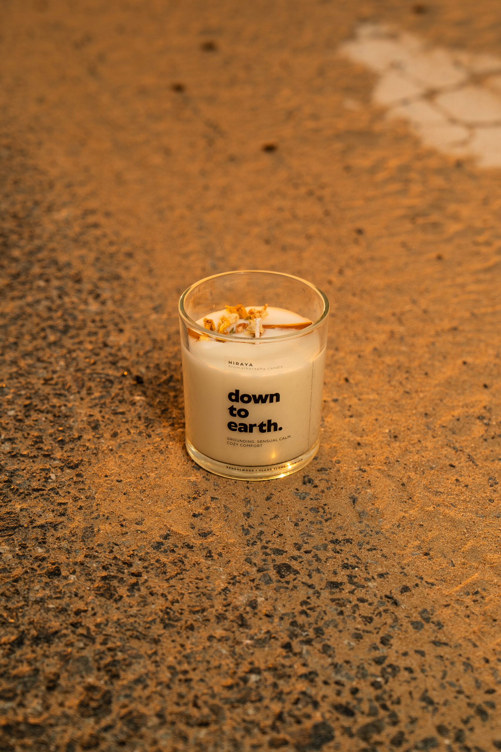 Desert‑inspired lifestyle photo of grounding sandalwood and ylang‑ylang candle for a cozy, earthy mood